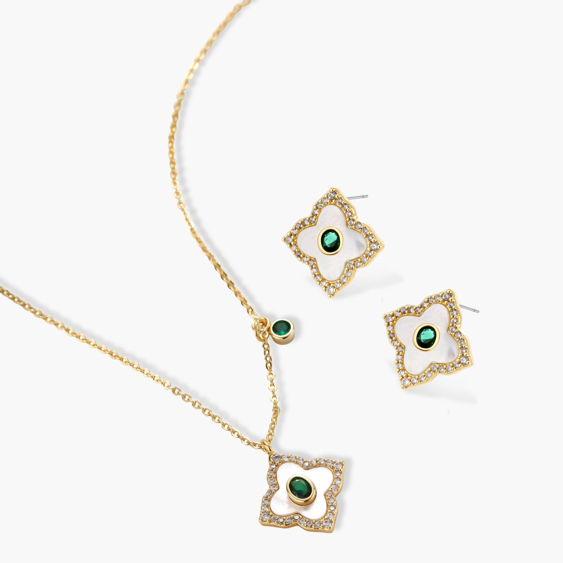 Gold-plated jewelry set with diamond-shaped pendants featuring white centers, green stones, and sparkling zirconia borders