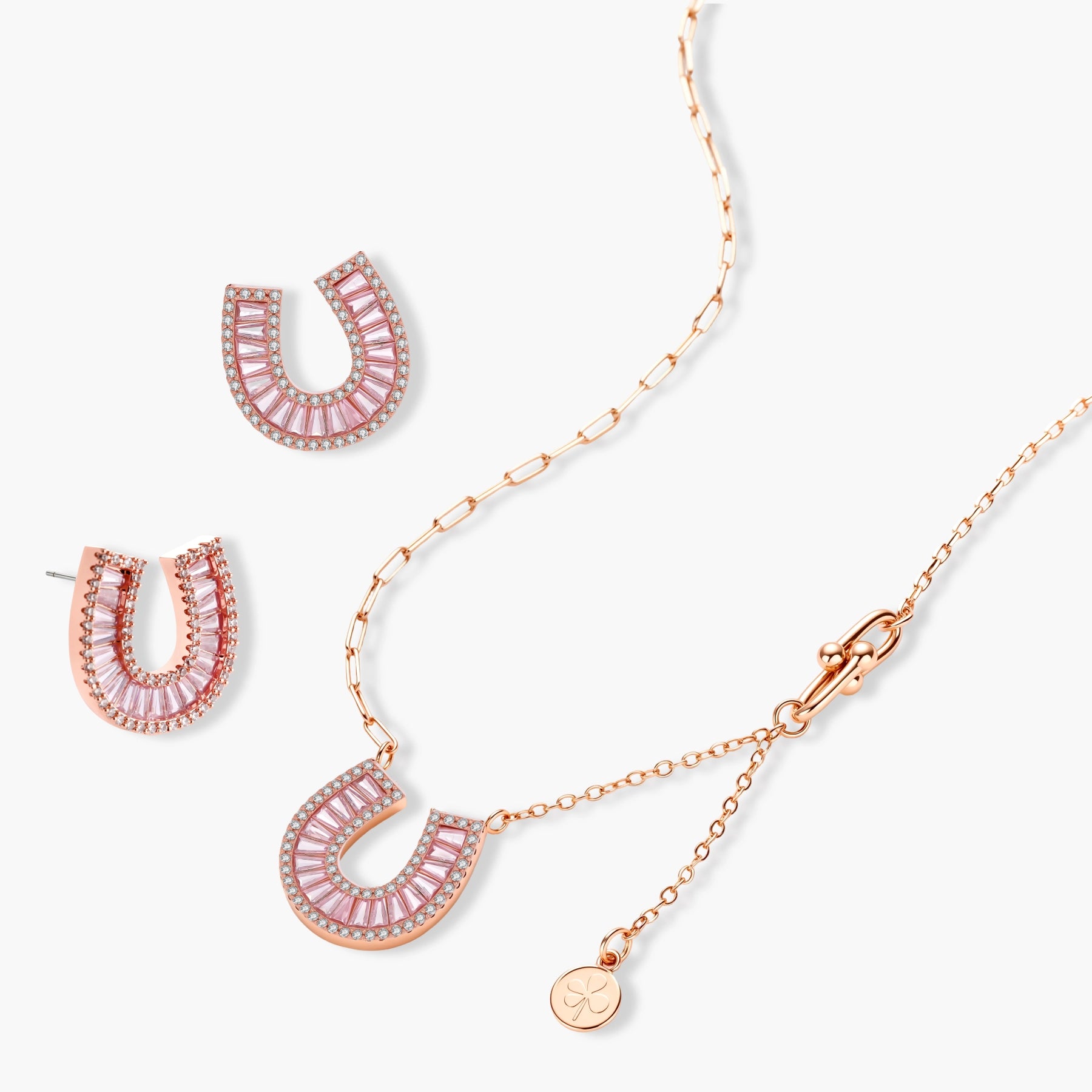 Sparkling horseshoe-shaped jewelry set with AAA cubic zirconia in gold-plated and white gold finishes on cream background.