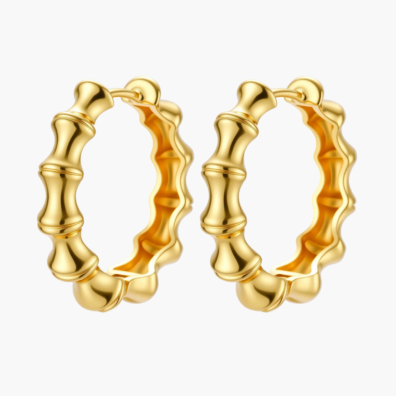 Close-up of gold-plated sterling silver hoop earrings with bamboo-inspired segmented design on white background.