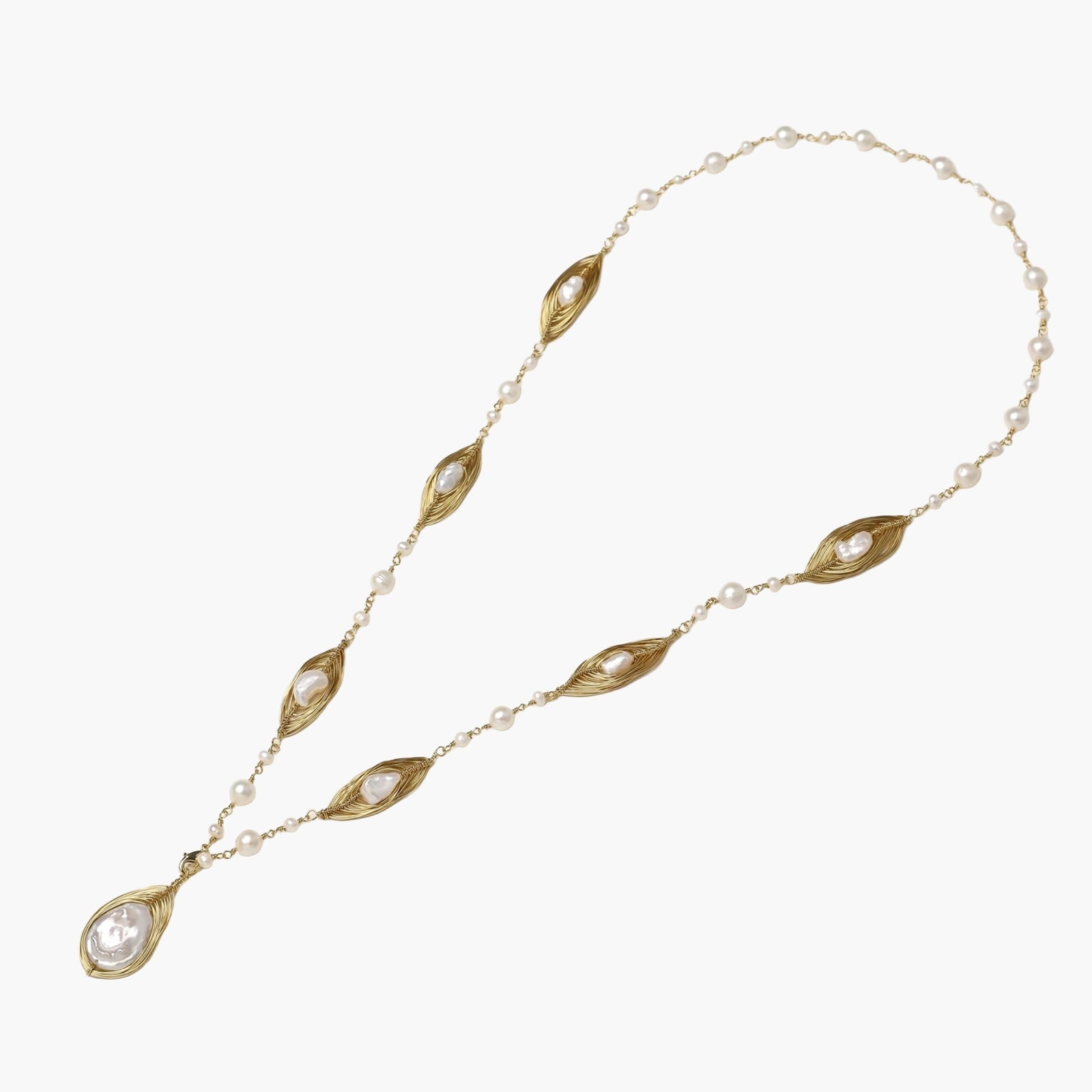 14K gold plated necklace with organic leaf motifs and freshwater pearls arranged in an elegant chain design on neutral background.