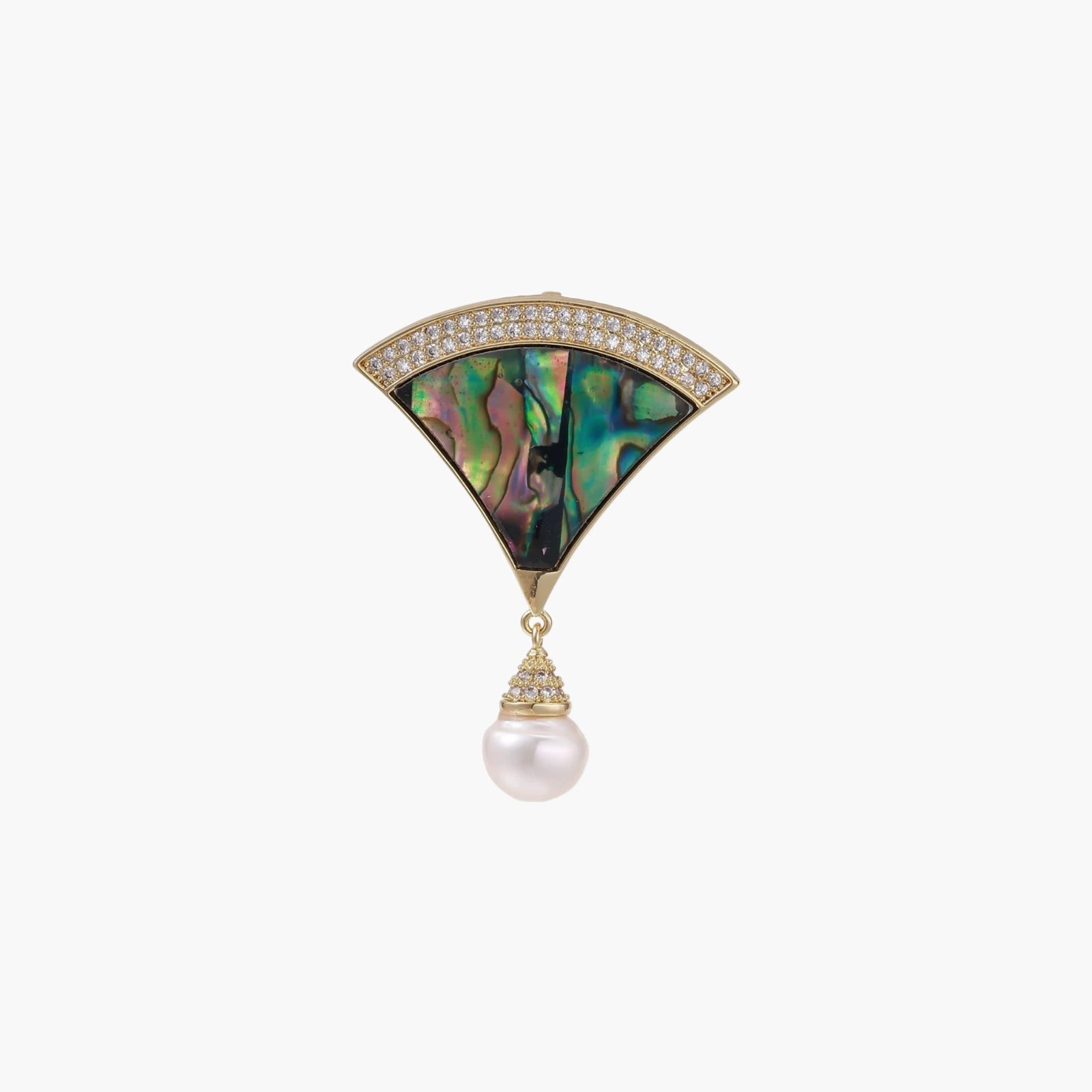 Gold fan-shaped brooch with iridescent abalone shell center, crystal border, and dangling white pearl on cream background