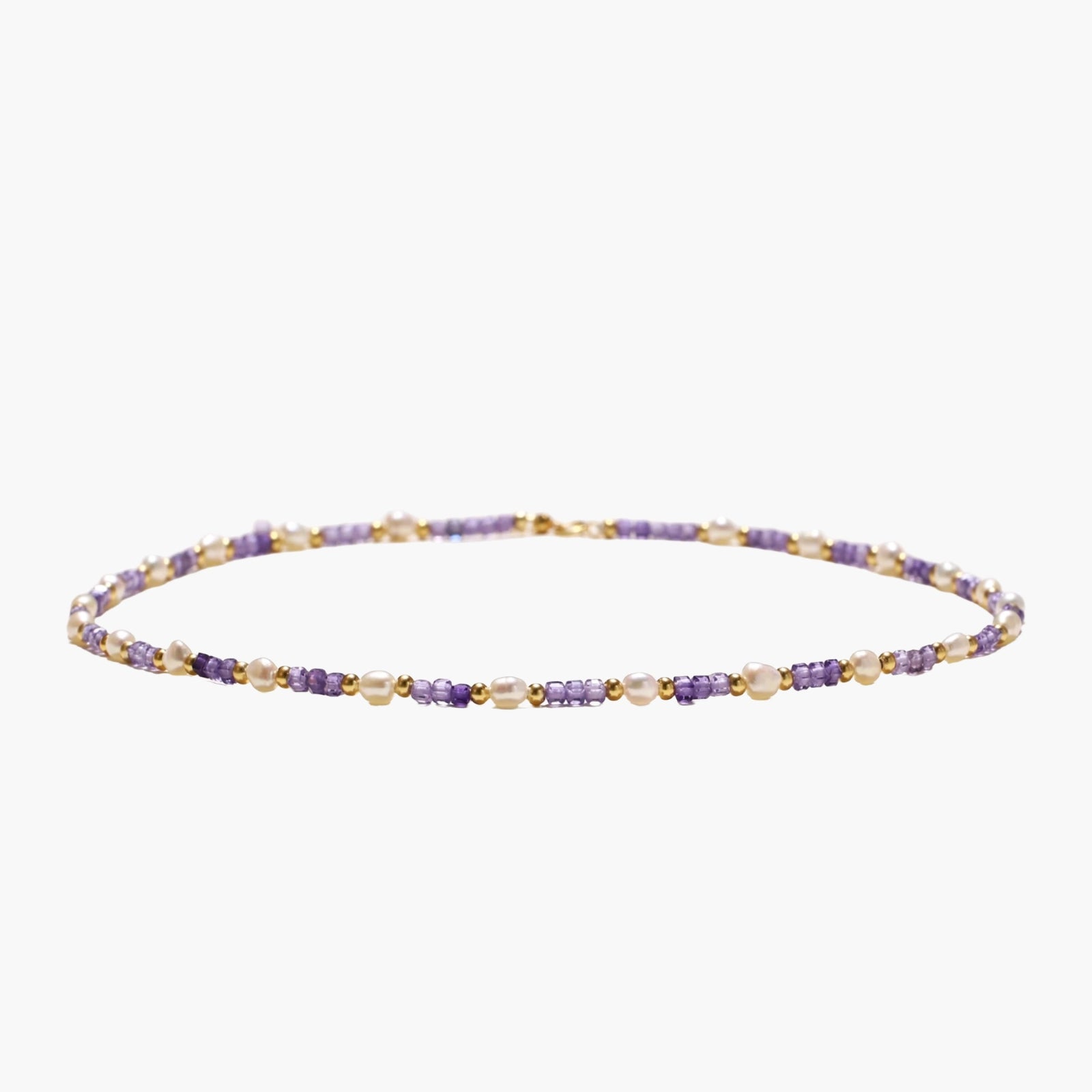 Delicate 18K gold vermeil necklace with alternating lavender zirconia beads and white freshwater pearls on cream background