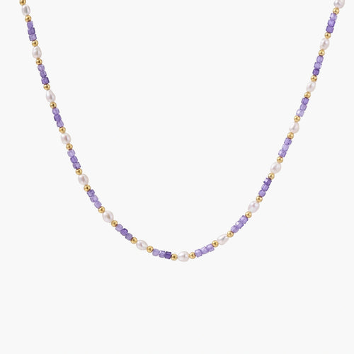 Delicate 18K gold vermeil necklace with alternating lavender zirconia beads and white freshwater pearls on cream background