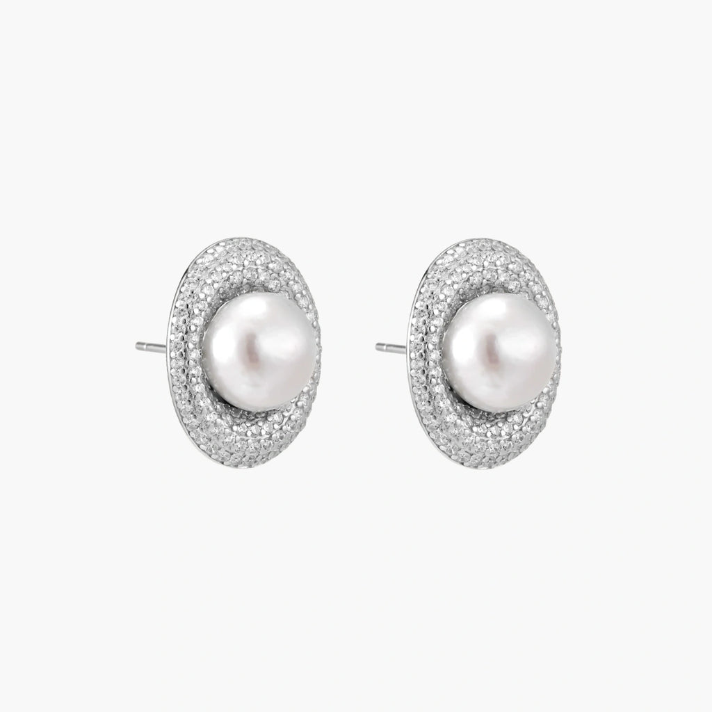 Elegant stud earrings with cream freshwater pearls surrounded by sparkly pavé crystals on rhodium-plated silver setting