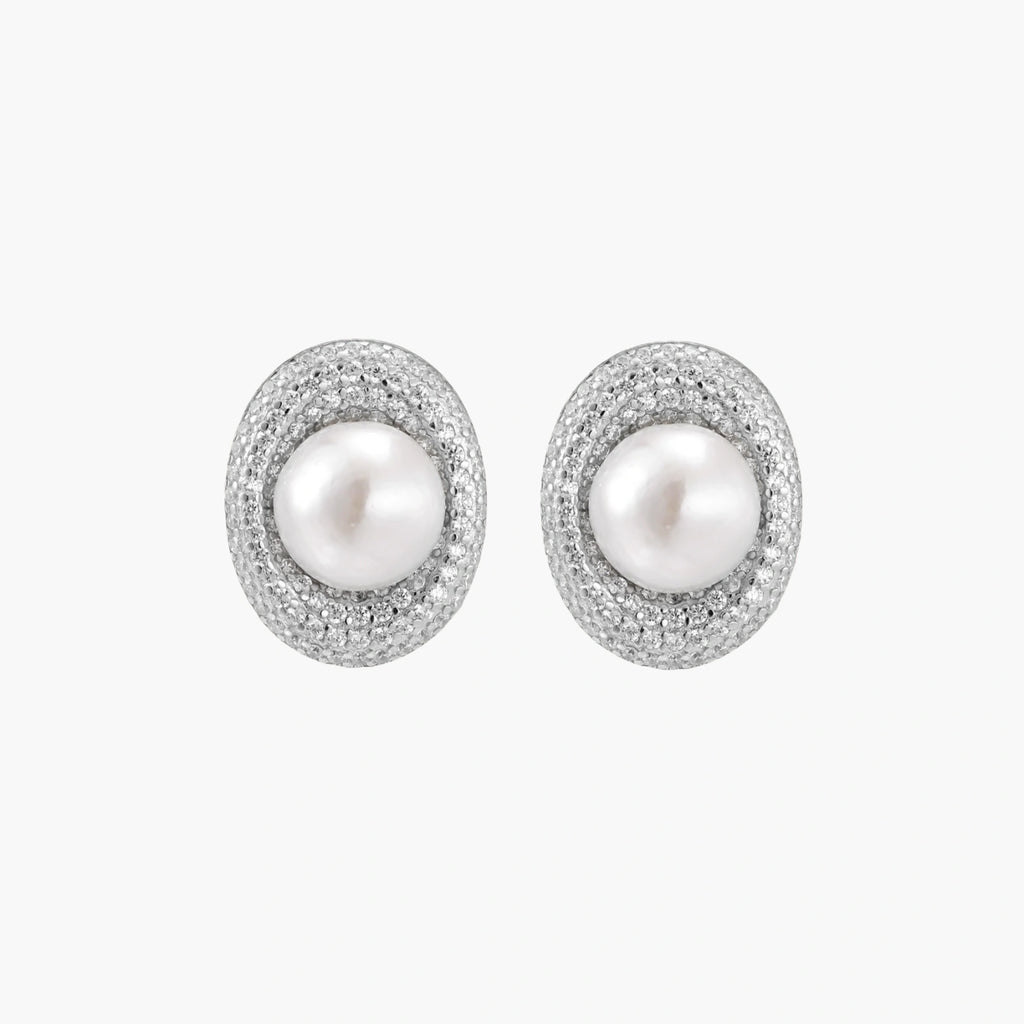 Elegant stud earrings with cream freshwater pearls surrounded by sparkly pavé crystals on rhodium-plated silver setting