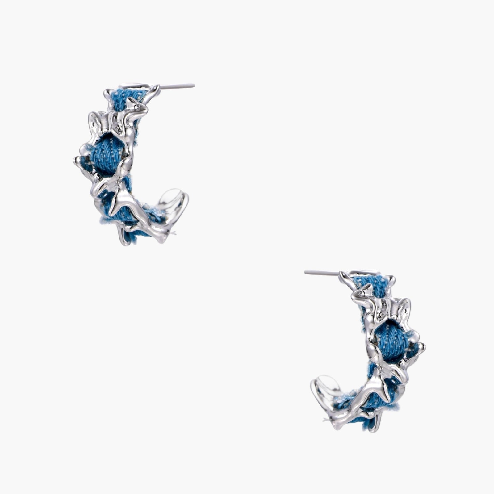White gold plated hoop earrings with woven blue denim fabric through organic branch-like metal framework