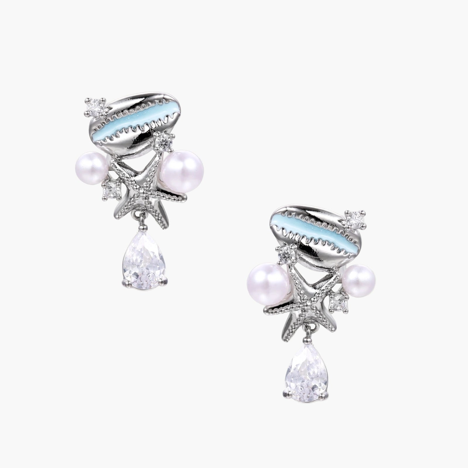 Coastal earrings with enamel cowrie shell, white pearls, starfish charm, and teardrop crystal on silver-toned metal