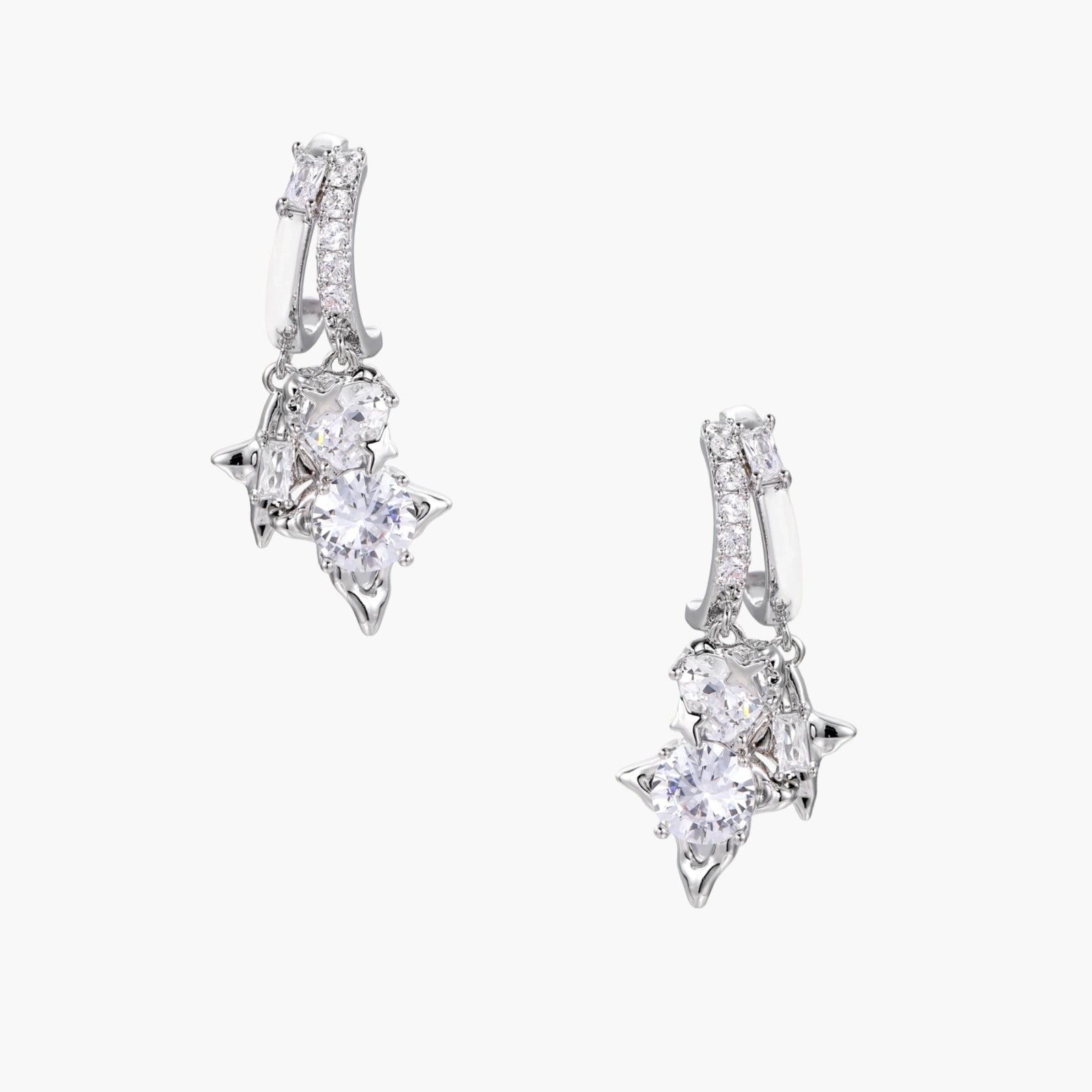 White gold-plated huggie earrings with geometric emerald-cut zirconia clusters in starburst formation on beige background