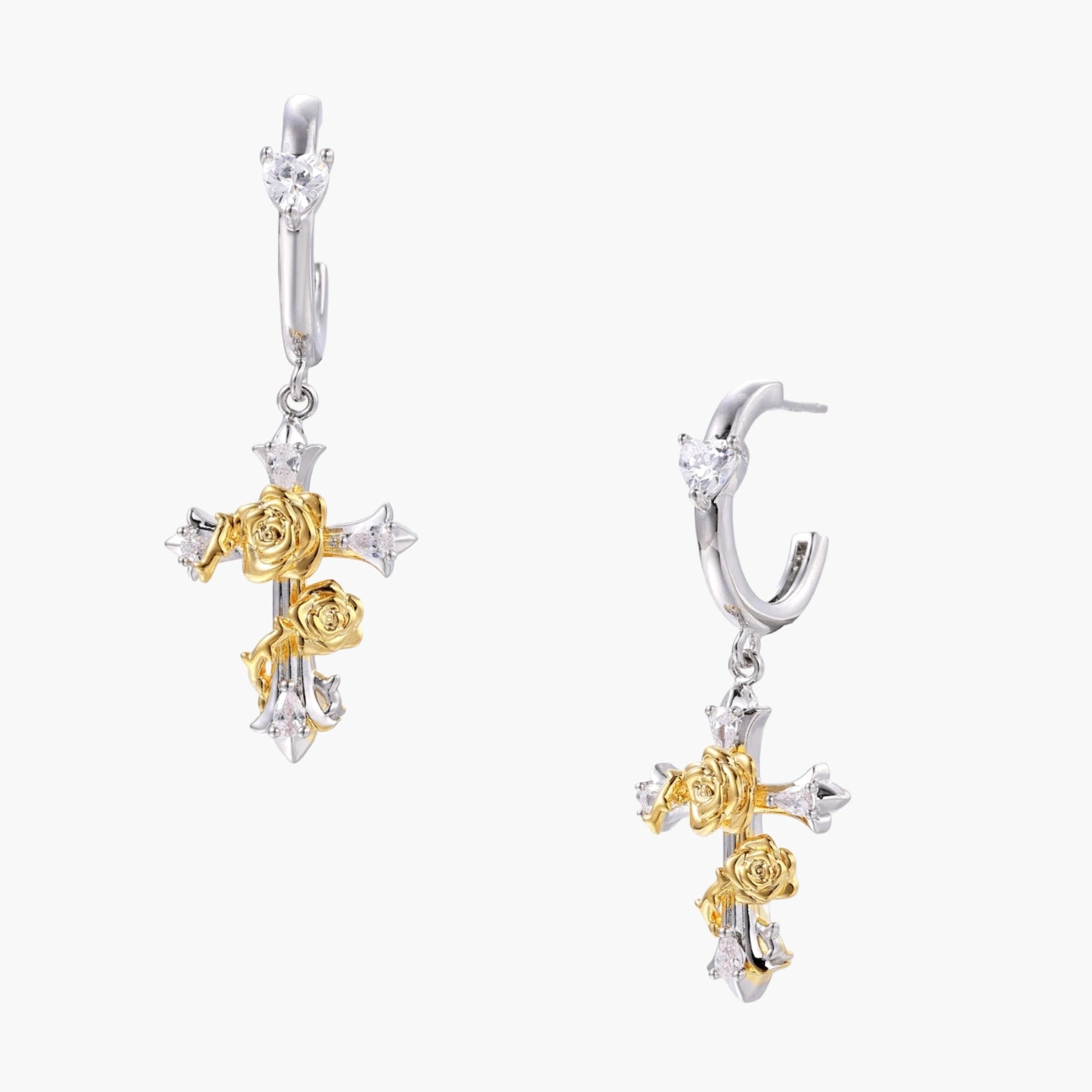 Two-tone huggie hoops with gold rose crosses and star zirconia accents on cream background