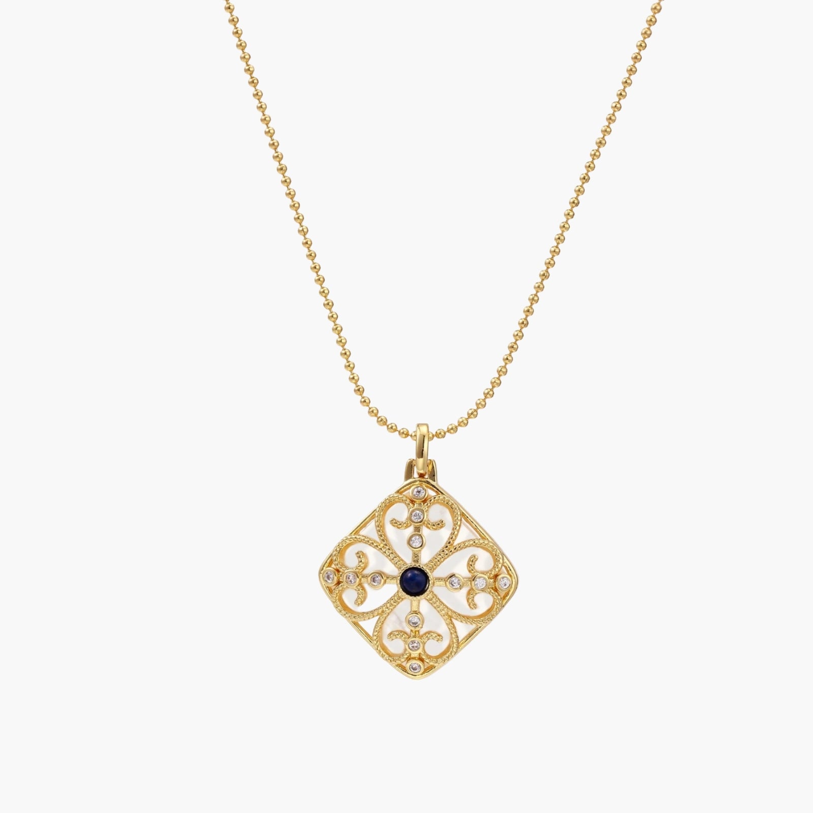 Gold filigree pendant with quatrefoil design, deep blue lapis lazuli center, clear crystal accents on ball chain