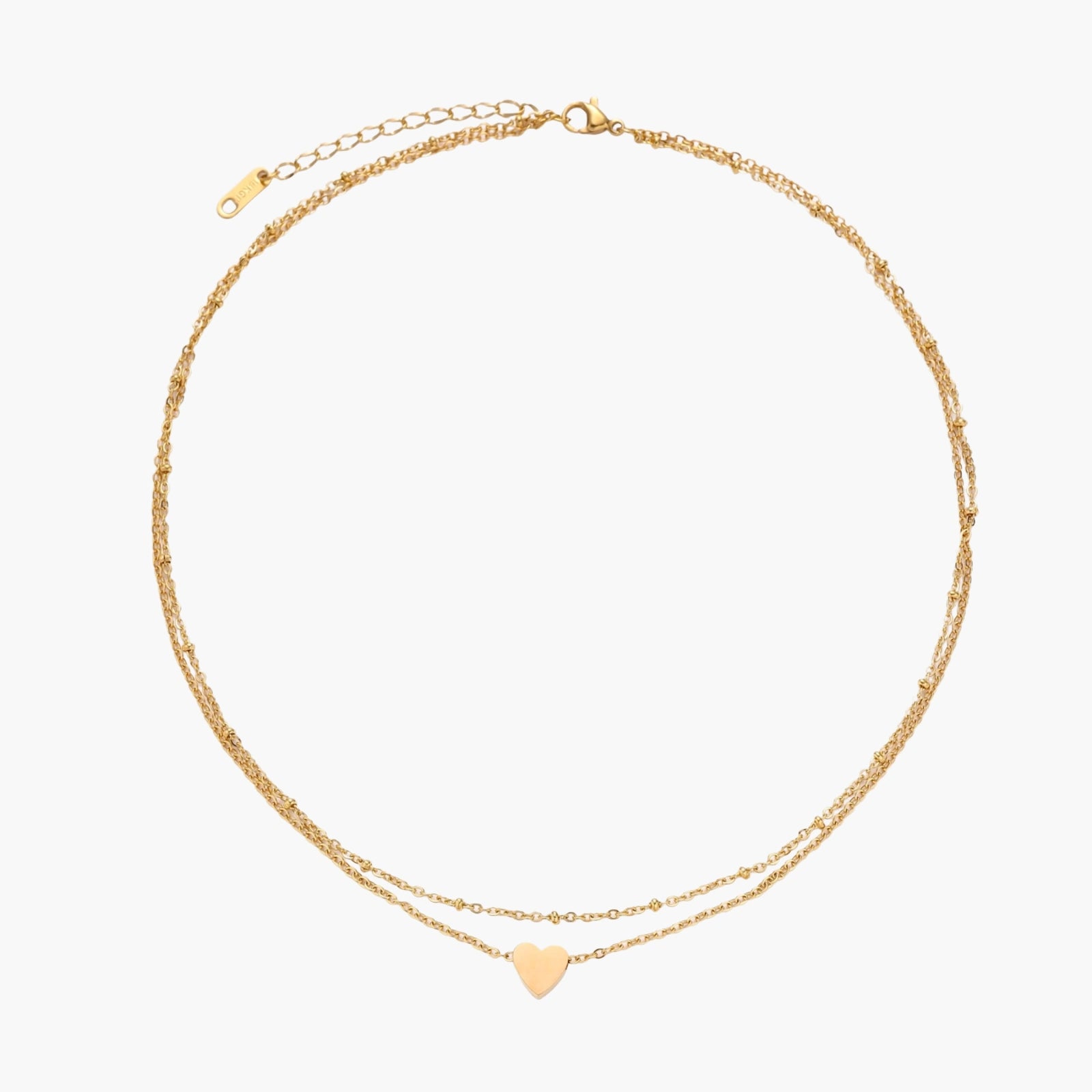 Delicate double-chain gold necklace with tiny heart pendant on cream background