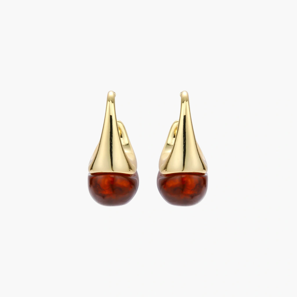 Modern drop earrings with curved gold-plated copper tops and amber resin bottoms creating an organic teardrop silhouette.