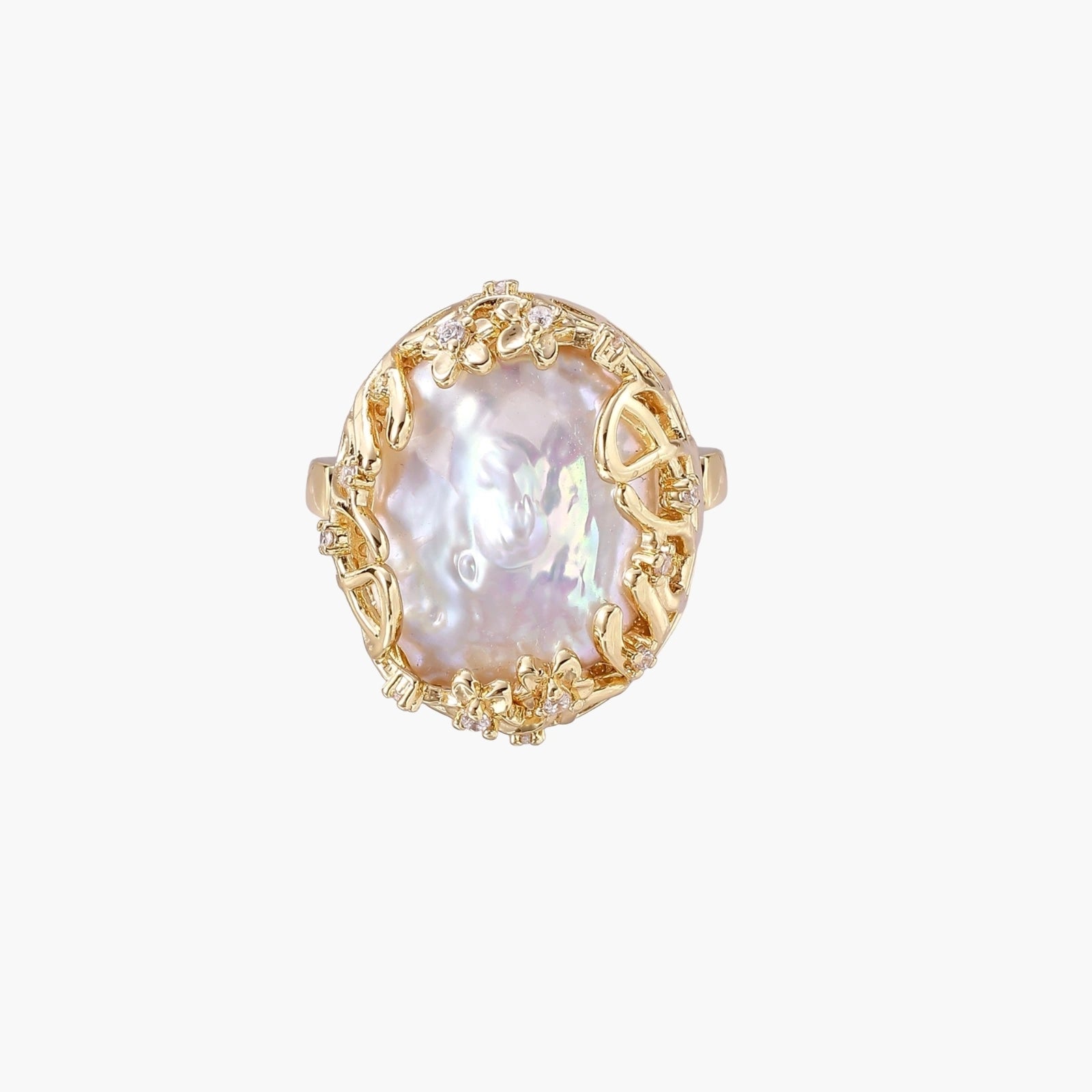 Gold filigree crown ring cradling an iridescent baroque freshwater pearl with crystal accents on white background
