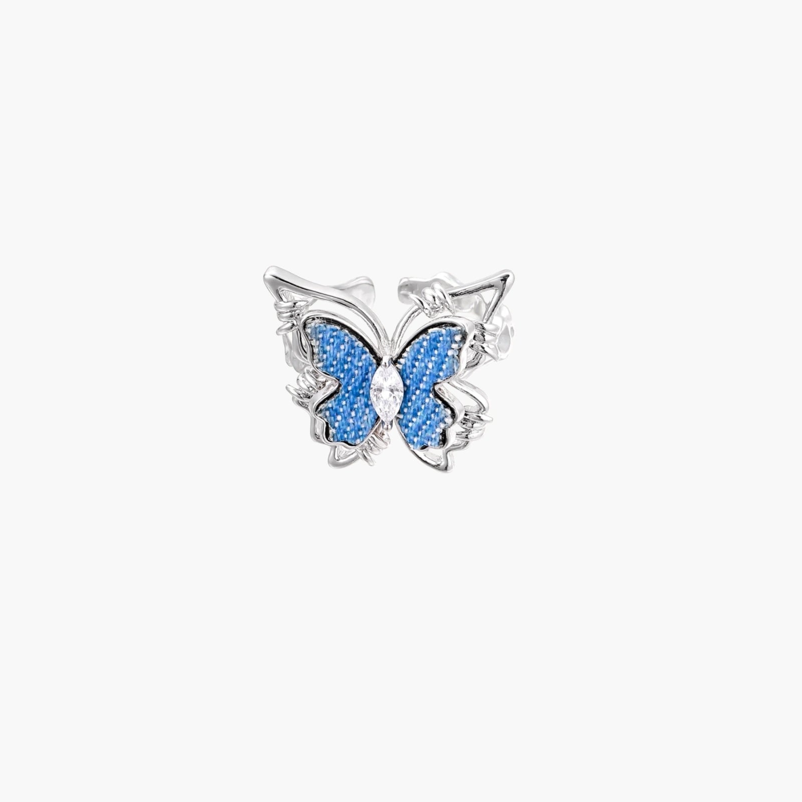 Silver-toned ring with blue denim butterfly wings, marquise zirconia center, and ornate scrollwork band on white background