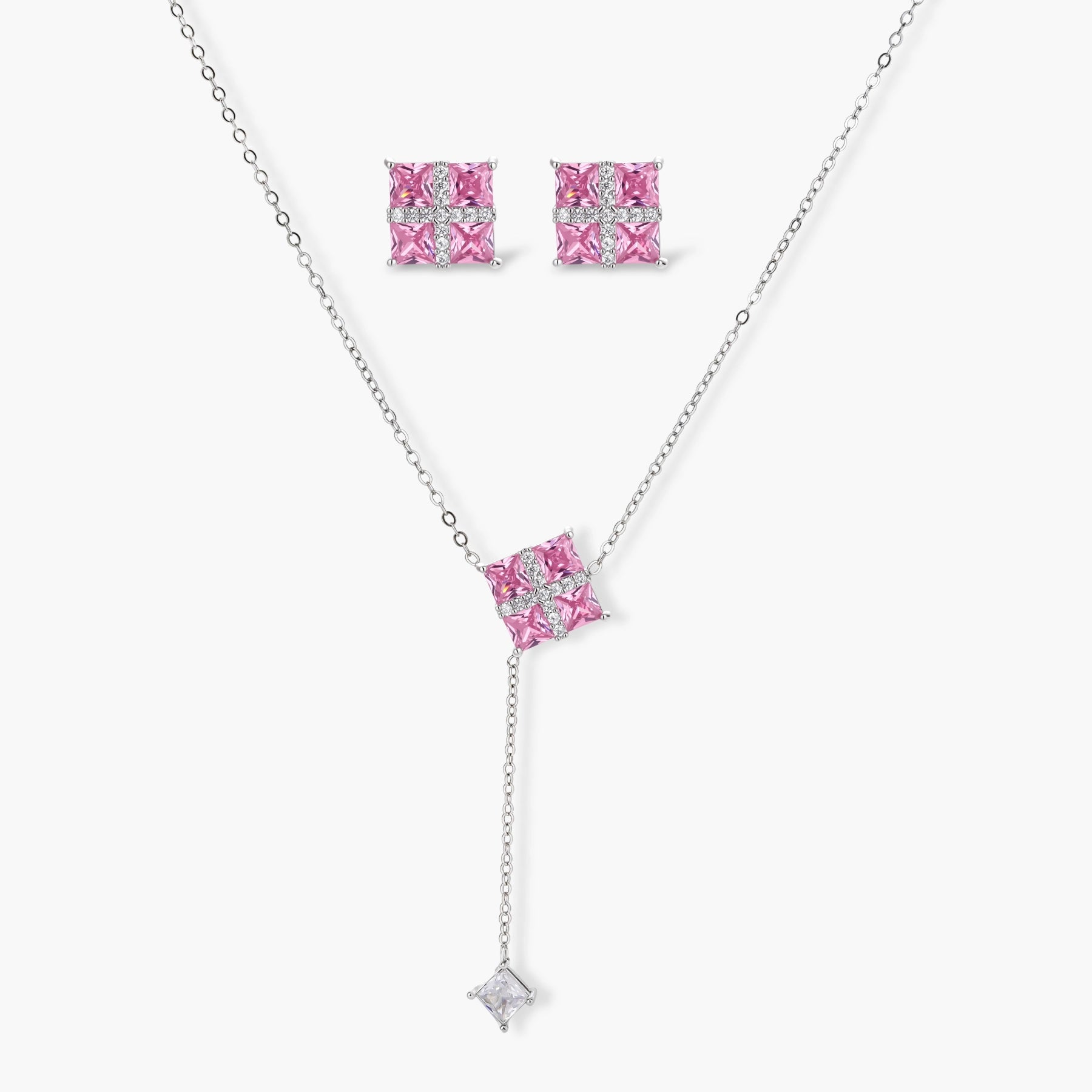 White gold plated jewelry set with pink cubic zirconia stones in geometric cross design, featuring Y-necklace and square stud earrings