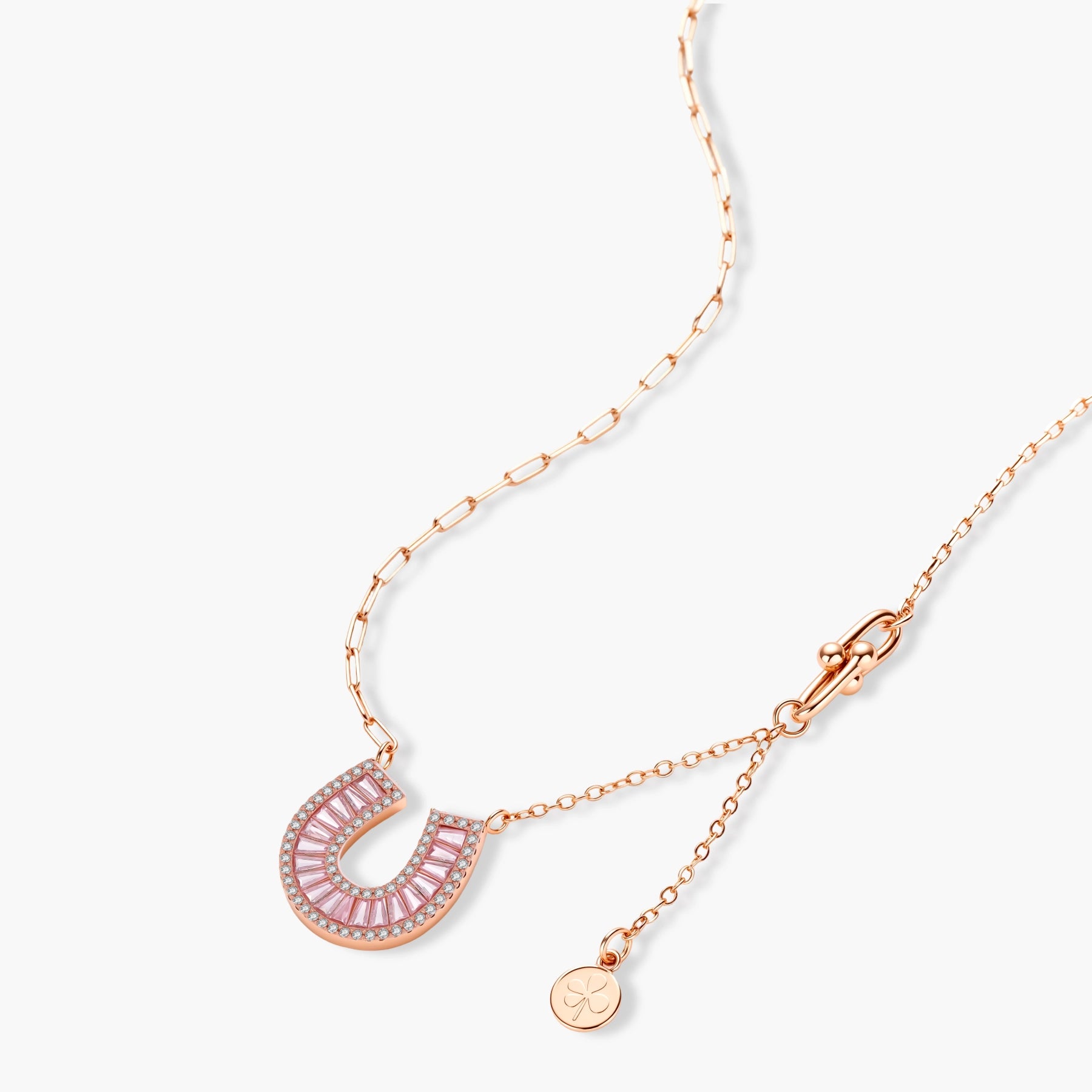 Sparkling horseshoe-shaped jewelry set with AAA cubic zirconia in gold-plated and white gold finishes on cream background.